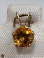 Front view of pendant showing citrine and prong setting