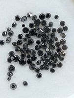 Close-up of assorted round black diamonds