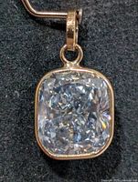 Front view of cushion-cut lab diamond pendant in yellow gold bezel