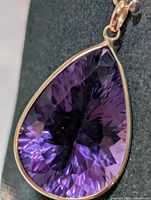 Front view of pear-shaped amethyst pendant in 10K gold