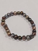 Bracelet overview showing multicolour pearls and butterfly accent