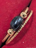 close-up of ring on red background showing pearl and beads