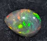Close view of black opal showing play-of-color