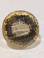 Front view of round faceted citrine gemstone