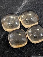 Four citrine cabochons close-up showing clarity and cut