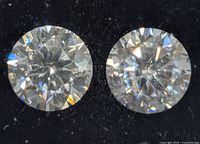 two moissanite stones close-up showing cut and clarity