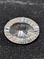 Top view of the faceted white quartz gemstone on black background