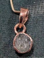 Front view of pendant showing rough diamond in bezel setting