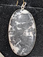 front view of oval zebra jasper pendant in silver setting