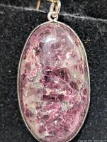 Front view of oval lepidolite pendant in silver bezel
