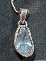 Full view of pendant front showing rough diamond and silver bezel