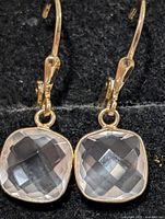 Front view of earrings showing rose quartz stones and lever-back hooks