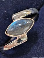 Front view of silver ring showing marquise labradorite stone and open wrap design