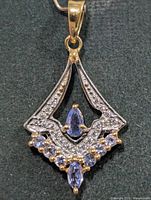 Front view of pendant showing overall design and stones