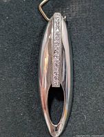 Front view of silver pendant showing CZ stone channel and open oval design