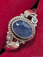 Top view showing oval iolite, rope bezel, swirl shoulders with accent stones