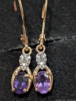 Both earrings front view showing amethysts and accent stones