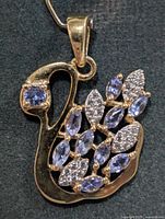 Front view of swan-shaped pendant showing gemstone arrangement