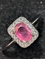 Front view of ring showing ruby and CZ halo