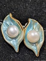 front view showing pearls on blue enamel leaves