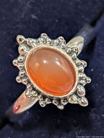 front view of ring showing carnelian cabochon and beaded halo