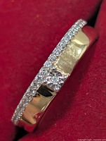 Angled view of silver diamond ring showing pave diamond accents