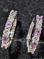 Front view of gemstone hoop earrings showing alternating stones