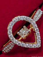 Front view of ring showing pear halo with diamond center