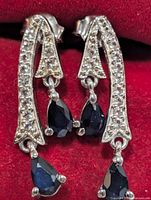Front view showing sapphire drops and pavé clear stones