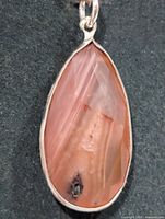Front view of teardrop royal imperial jasper pendant in silver bezel