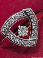 front view showing triangular halo with pavé diamonds and floating centre diamond