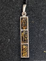 Front view showing three amber cabochons in silver setting
