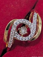 Front view showing swirl design and pavé diamonds