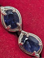 close-up of two sapphires in silver setting