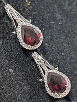 Front view showing garnet and CZ halo earrings