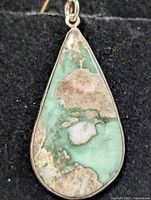 Front view of teardrop variscite pendant in silver bezel