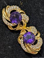 Front view of both earrings showing amethyst centres and accent stones