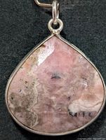 Front view of teardrop rhodochrosite pendant in silver bezel
