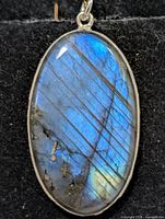 front view of oval labradorite pendant in silver bezel