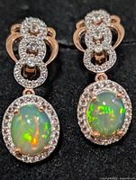 Front view of both earrings showing opals and CZ borders