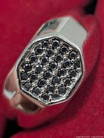 Close-up of ring face showing black onyx stones in octagonal setting