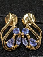 Front view showing tanzanite stones and gold-tone silver setting