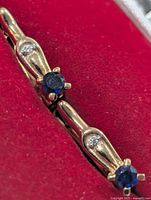 Close view of sapphire and accent stones set in silver earring