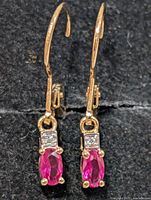 Front view of earrings showing created rubies and clear stones