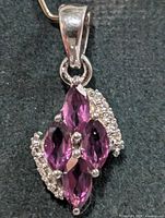 Front view of pendant showing garnets and accent stones