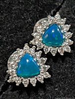 Front view of both earrings showing opal triplets and halo stones