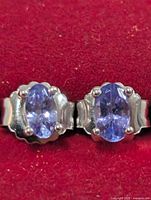 Front view of both earrings showing tanzanite stones and settings