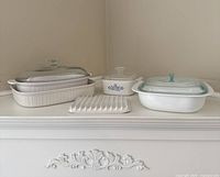 All CorningWare pieces arranged on shelf showing dishes and lids
