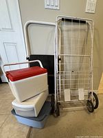 All items grouped: folding grocery cart, two-step ladder, Thermos cooler, two storage tubs