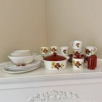 Complete fruit motif stoneware set arranged on surface